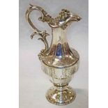 AN ATTRACTIVE VICTORIAN SILVER PLATED CLARET JUG, with double scroll handle and hinge top,