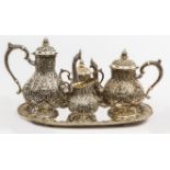 A FIVE PIECE SIAM STERLING SILVER REPOUSSÉ AND COFFEE SERVICE with oval tray,