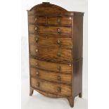 A REGENCY PERIOD BOW FRONTED SECRETAIRE CHEST ON CHEST, with arched and inlaid cornice,