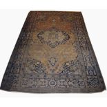 AN ANTIQUE PART SILK PERSIAN RUG with centre medallion on an all over floral field with navy