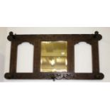 A CARVED OAK HAT AND COAT WALL BRACKET, with centre mirror plate and wooden legs,