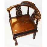 A 17TH CENTURY STYLE CARVED OAK CORNER CHAIR,