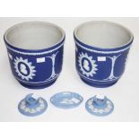 A FINE PAIR OF WEDGWOOD BLUE JASPERWARE JARDINIERES, each with three relief portraits,