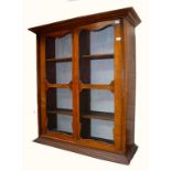 A SMALL DEAL BOOKCASE, with two sliding doors,