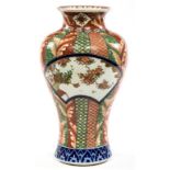 A BALUSTER SHAPED PORCELAIN VASE, with decorated striped panels and larger shaped floral panels, 22.