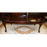 A GOOD CHIPPENDALE STYLE MAHOGANY DINING TABLE, the top with a gadroon edge and two spare leaves,