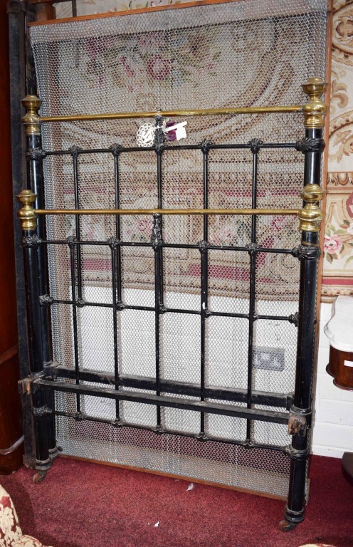 A THREE FOOT SIX INCH TUBULAR METAL AND BRASS MOUNTED BED, with spring and sides.