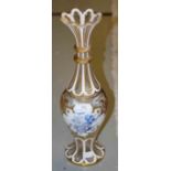 A BOHEMIAN BALUSTER SHAPED GLASS VASE, the flared neck with two facet cut collars,