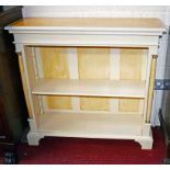 A SMALL PAINTED WOODEN OPEN BOOKCASE