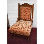 AN EDWARDIAN OAK ARMCHAIR,