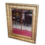 A LEAF MOULDED GILT WALL MIRROR, 30" (77cm)h x 36" (92cm).