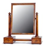 A VICTORIAN WALNUT DRESSING MIRROR, THE BEVELLED PLATE BETWEEN TAPERED COLUMNS WITH DOMED FINIALS,