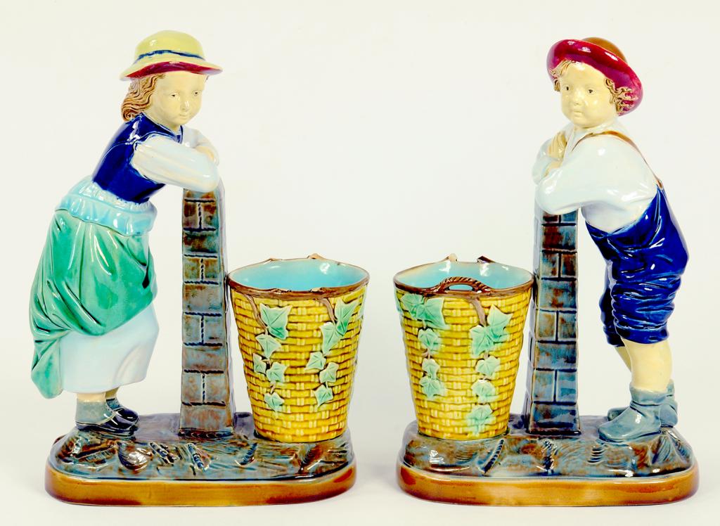 A PAIR OF VICTORIAN MAJOLICA BOY AND GIRL WITH BASKET SPILL VASES, CIRCA 1880