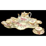 A GEORGE JONES CRESCENT CHINA SHELL MOULDED CABARET SET, PRINTED AND PAINTED WITH NATURALISTIC