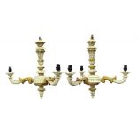 A PAIR OF CARVED CREAM AND GILT PAINTED WOOD CHANDELIERS, 50CM H