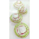 A WEDGWOOD BONE CHINA FLUTED APPLE GREEN GROUND CUP AND SAUCER DECORATED WITH SWAGS AND A