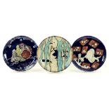 THREE SOUTH EAST ASIAN BLACK GLAZED EARTHENWARE PLATES, VARIOUSLY DECORATED, 26CM DIAM, 20TH