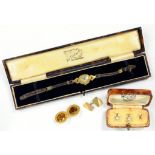 A GOLD CUFFLINK, A GOLD LADY'S WRISTWATCH, A SET OF THREE DRESS STUDS, CASED (ONE DAMAGED) AND A