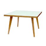 A JAMES BURLEIGH LIGHTWOOD AND WHITE LAMINATE TABLE ON TAPERING SPLAYED LEGS, 120CM X 120CM