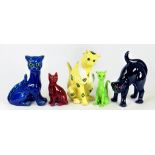 AN ALLER VALE BLUE GLAZED EARTHENWARE CAT WITH GREEN GLASS EYES AND FIVE SIMILAR CONTEMPORARY MODELS