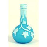 A CAMEO GLASS MINIATURE VASE, OF BOTTLE SHAPE IN TURQUOISE GLASS OVERLAID IN WHITE AND CARVED WITH