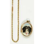 A LATE VICTORIAN GOLD PLATED AND ENAMEL LOCKET, PAINTED WITH THE HEAD OF A SPANIEL AND A GOLD