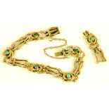 A GOLD BRACELET SET WITH TURQUOISE CABOCHONS AT INTERVALS, MARKED 15CT, CIRCA 1910 (PART
