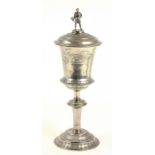 A DANISH SILVER CUP AND COVER, THE DOMED COVER WITH FIGURAL FINIAL IN THE FORM OF THOR, 30CM HIGH,