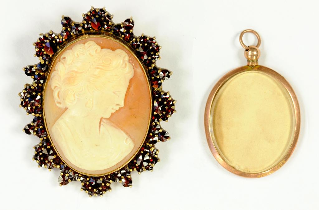 A CAMEO BROOCH WITH GARNET SURROUND AND A GOLD PHOTO LOCKET