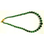A NECKLACE OF MALACHITE BEADS WITH ASSOCIATED GOLD HAND CLASP