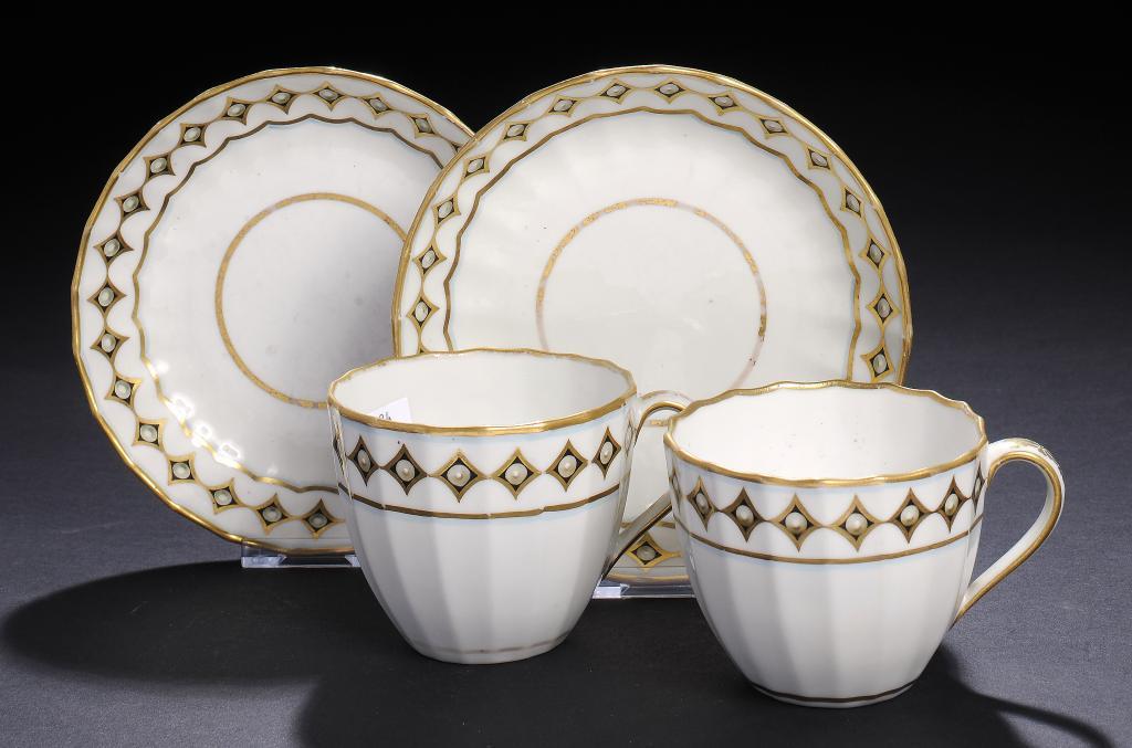 A PAIR OF DERBY FLUTED TEACUPS AND SAUCERS, C1790  painted with a border of 'pearls', saucer 13cm