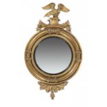 A GEORGE IV GILTWOOD MIRROR, C1830 the leaf clasped circular frames crested by an eagle displayed,