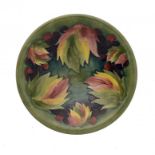 A MOORCROFT LEAF AND BERRY BOWL, C1945-49 25.5cm diam ++Light staining of the glaze inside the