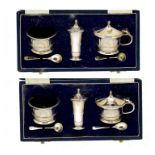 A MODERNIST SILVER SIX PIECE CONDIMENT SET with spoons and blue glass liners, pepper casters 7cm