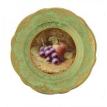 A COALPORT APPLE GREEN GROUND PLATE, 1915 painted by F H Chivers, signed, with fruit on a mossy bank