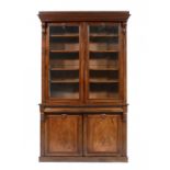 A VICTORIAN MAHOGANY BOOKCASE, C1860 with curl veneered panels to the lower doors, 260cm h; 51 x