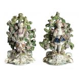 A PAIR OF DERBY FIGURES OF FLOWER GATHERERS, C1770 standing before a profusely flowered bocage on