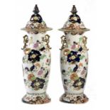 A PAIR OF STAFFORDSHIRE IRONSTONE TYPE JAPAN PATTERN ALCOVE VASES AND COVERS, C1850 with pineapple