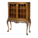 A WALNUT AND BURR WALNUT SERPENTINE CHINA CABINET, MID 20TH C crossbanded throughout, with carved