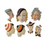 SIX CZECHOSLOVAKIAN ART DECO EARTHENWARE WALL MASKS AND A SIMILAR W GOEBEL MASK, C1930 including a