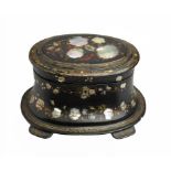 A VICTORIAN OVAL PAPIER MÁCHÉ TEA CADDY, C1850 inlaid with mother of pearl, painted with flowers and