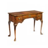 A WALNUT WRITING TABLE, C1930 in the form of a George III lowboy with tooled leather inlet top, 75cm