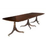 A GEORGE II STYLE MAHOGANY TRIPLE PILLAR DINING TABLE, C1930 the crossbanded top with two leaves,