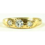 A DIAMOND THREE STONE RING, GYPSY SET, IN GOLD, MARKED 18CT, 1.9G GROSS