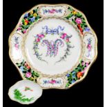 A GERMAN PORCELAIN RETICULATED PLATE PAINTED WITH A MONOGRAM OF ROSES AND FORGET ME NOTS IN PANELLED