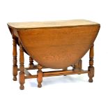 AN OAK GATELEG TABLE WITH OVAL TOP