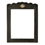 AN INDIAN INTRICATELY CARVED AND EBONISED MIRROR OR PICTURE FRAME, INSET WITH AN OVAL MINIATURE,