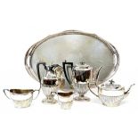 AN EPNS OVAL GALLERY TRAY, 65CM W, AN EPNS VASULAR COFFEE POT, A LIDDED JUG AND A TEA SERVICE