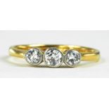 A DIAMOND THREE STONE RING, IN GOLD, MARKED 18CT PT, 2.3G GROSS