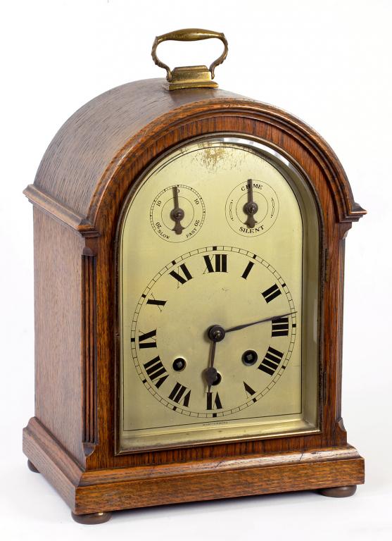 A GERMAN OAK BRACKET CLOCK, THE SILVERED DIAL WITH TWIN SUBSIDIARY DIALS TO THE ARCH, THE MOVEMENT